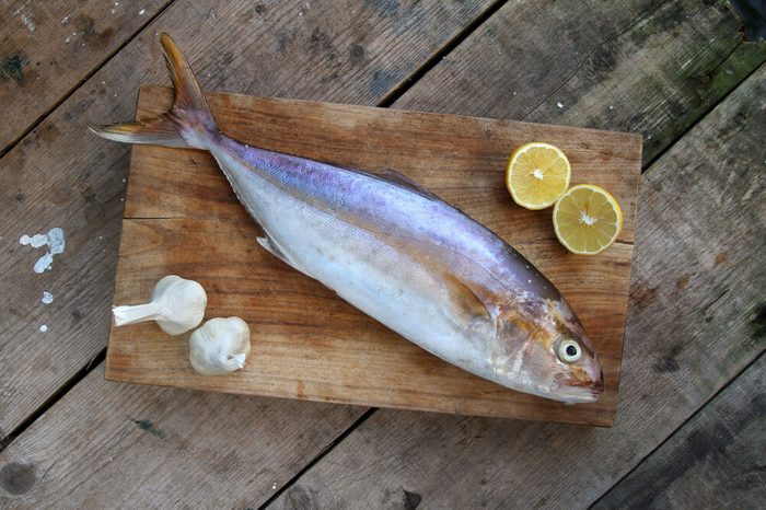 raw fish on a wooden background - Yellowtail - Greater amberjack - gof