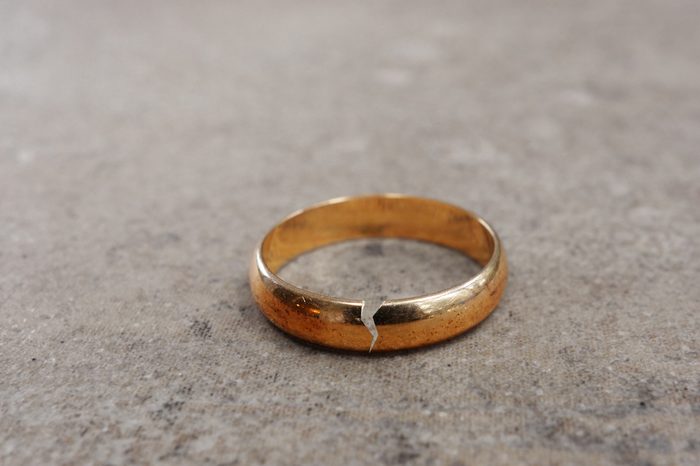 Gold wedding ring with a crack in it -- divorce concept