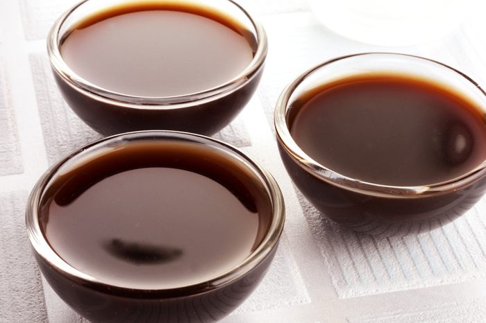 THREE GLASS BOWLS FILLED WITH WORCESTER SAUCE