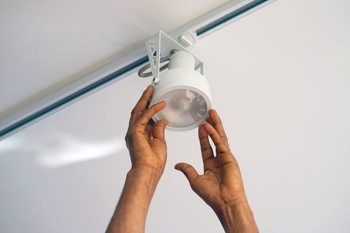 Electric hand lamps with ceiling LED lamp, spotlight. The concept of repair and maintenance.