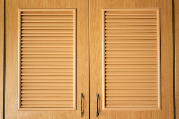 Wooden door of wardrobe in kitchen for being design interior of creative background, with flat pattern in surface