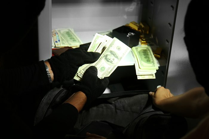 Thieves stealing money from safe
