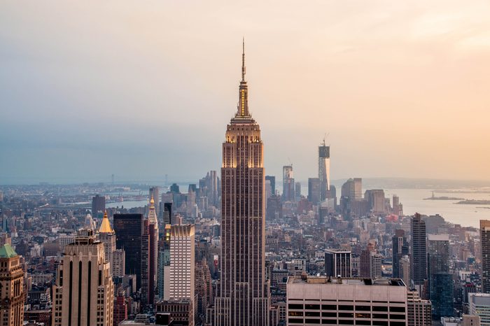 New York City skyline with urban skyscrapers at sunset. 