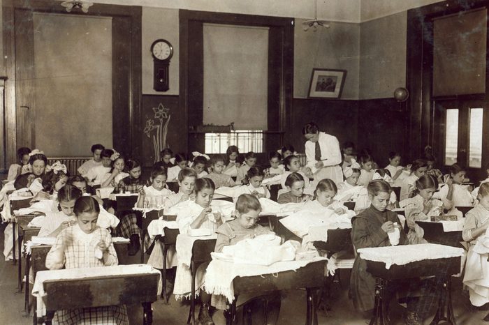 an American school teaching girls how to sew