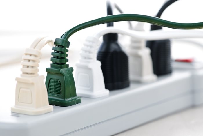 Many plugs plugged into electric power bar