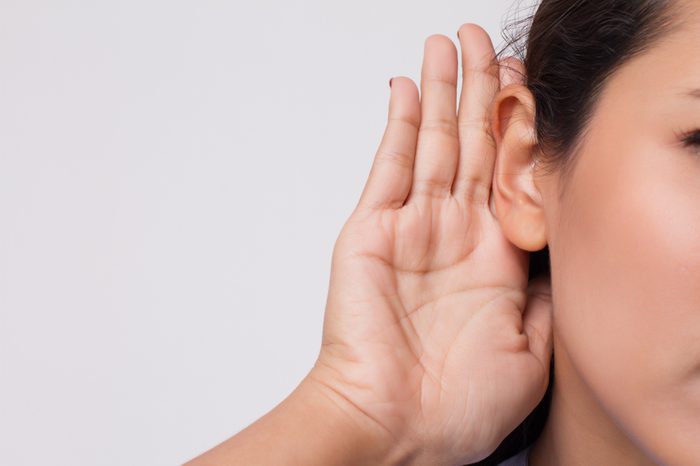 sad frustrated unhappy woman listening ear to bad news or having hearing impair, hard of hearing