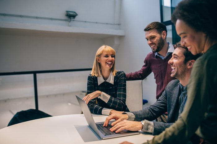 Group of coworkers laughing during a meeting