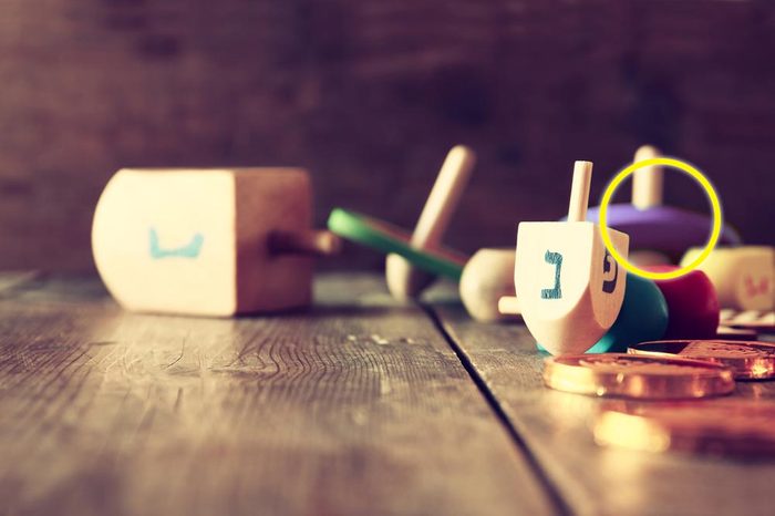 Image of jewish holiday Hanukkah with wooden dreidels colection (spinning top) and chocolate coins on the table