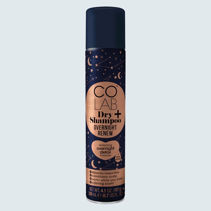 A can of CO LAB Dry Shampoo stands upright. It features night sky imagery with text describing its overnight renew benefits and calming scent.