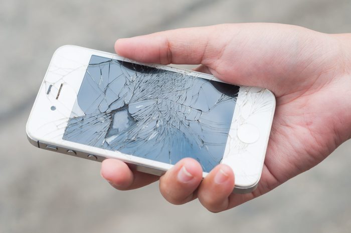 Hands holding broken mobile smartphone
