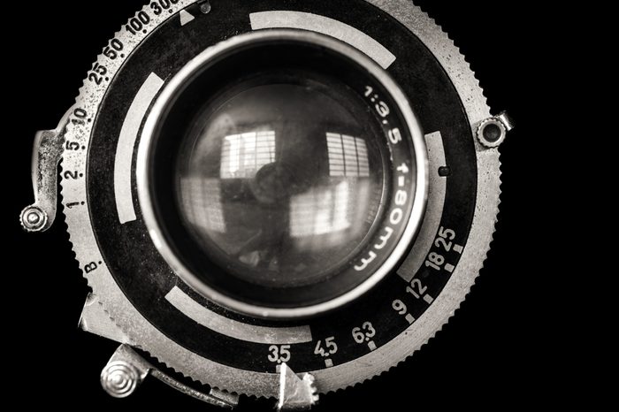 Vintage camera lens close-up isolated on black