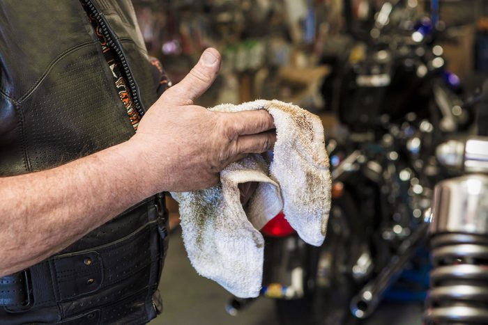Wiping Hands With Oily Rag