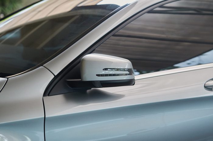 Rear-view mirror closed for safety at car park, Side mirror of gray car , black tinted glass