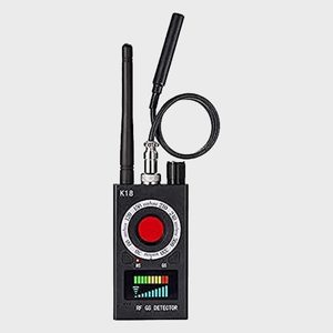 Device detects signals; features antennas and dials; displays readings on a screen. Surrounding area is plain, white background. Text includes 