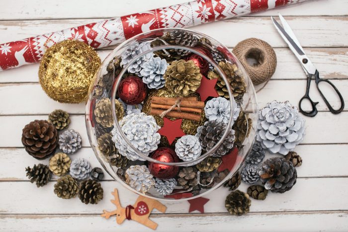 Decorating Christmas table with pine cones