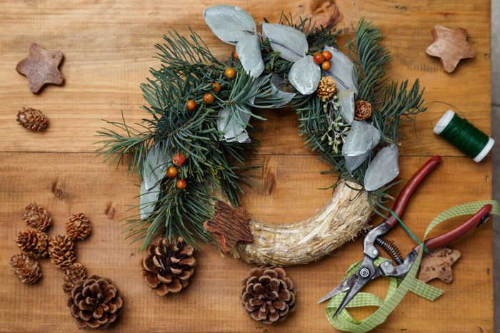 Top down view of florist's worktable. Making of Christmas wreath. Copy space - perfect for a festive card.