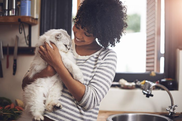 woman holding cat