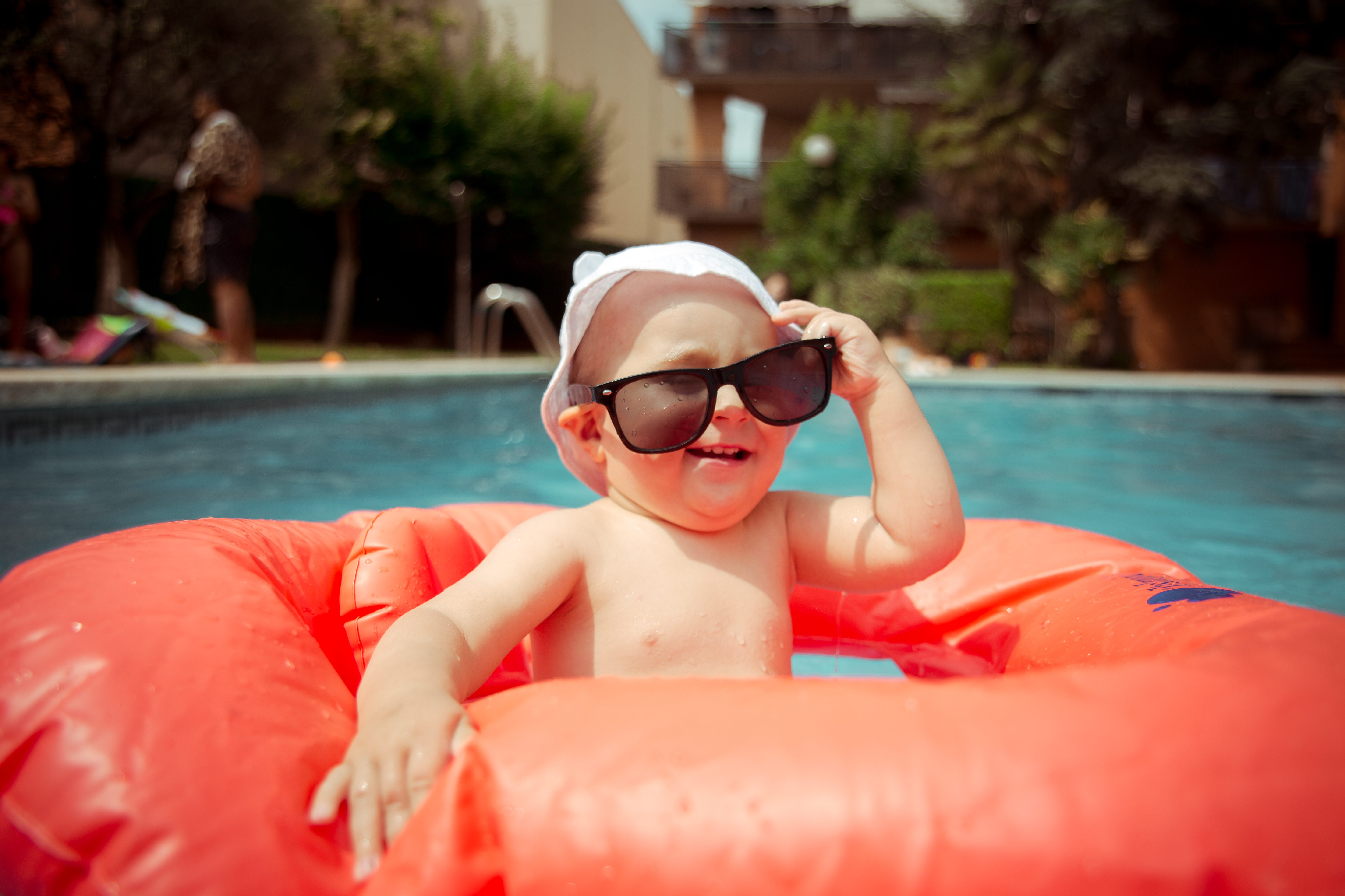 Baby boy wearing sunglasses at the pool