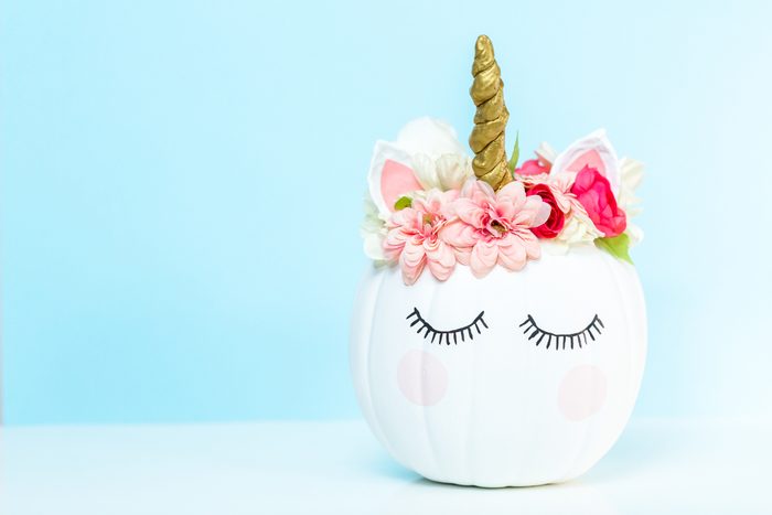 Craft pumpkin painted white and decorated with pink flowers