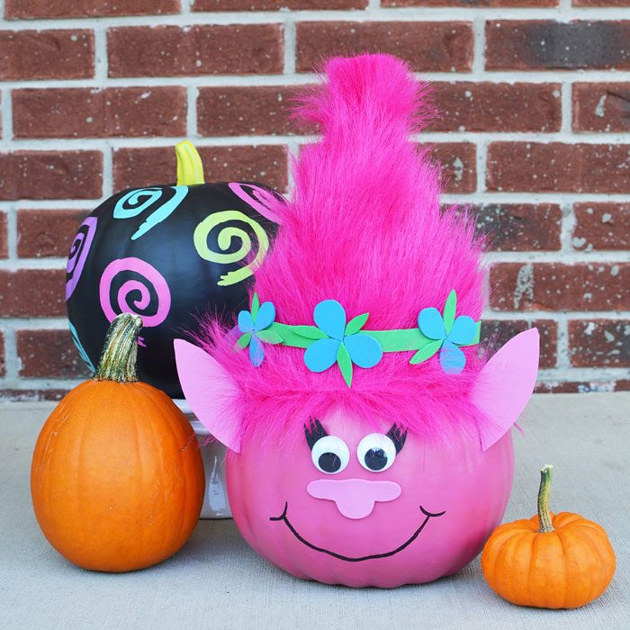 pumpkin painted to look like a troll with added ears and hairstyle
