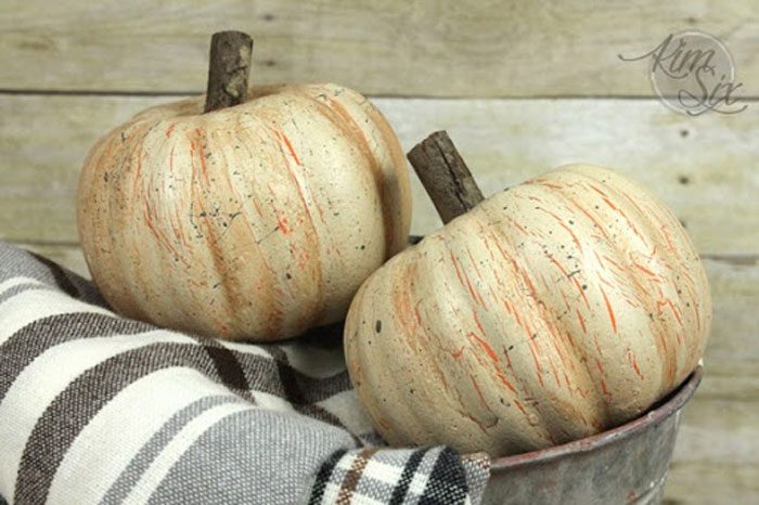 pumpkins painted in a way that gives them a distressed textural look