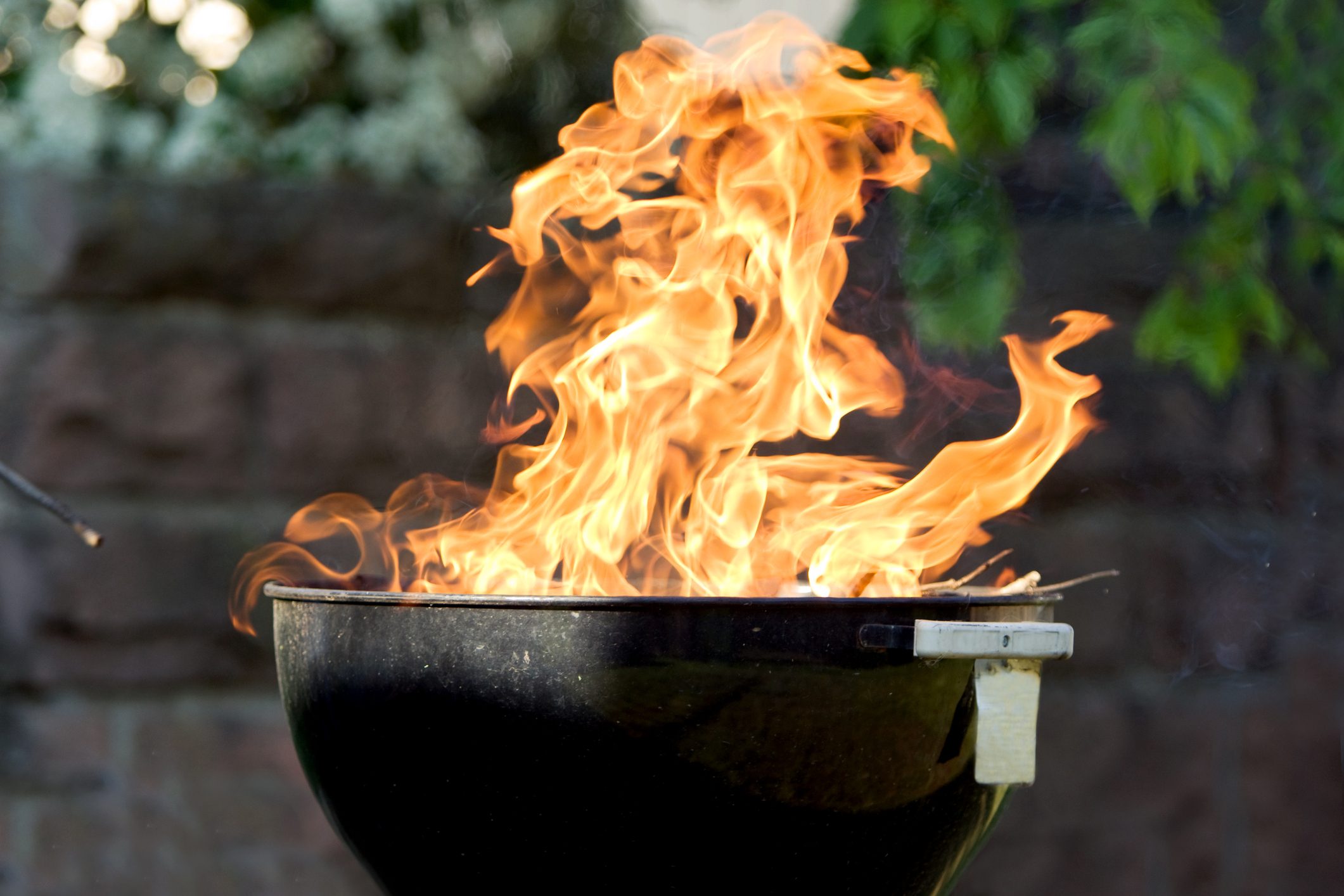 Raging fire from charcoal barbecue grill