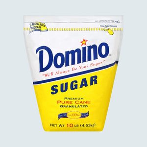 A 10-pound Domino Sugar bag sits upright. The bag is white and yellow, labeled 