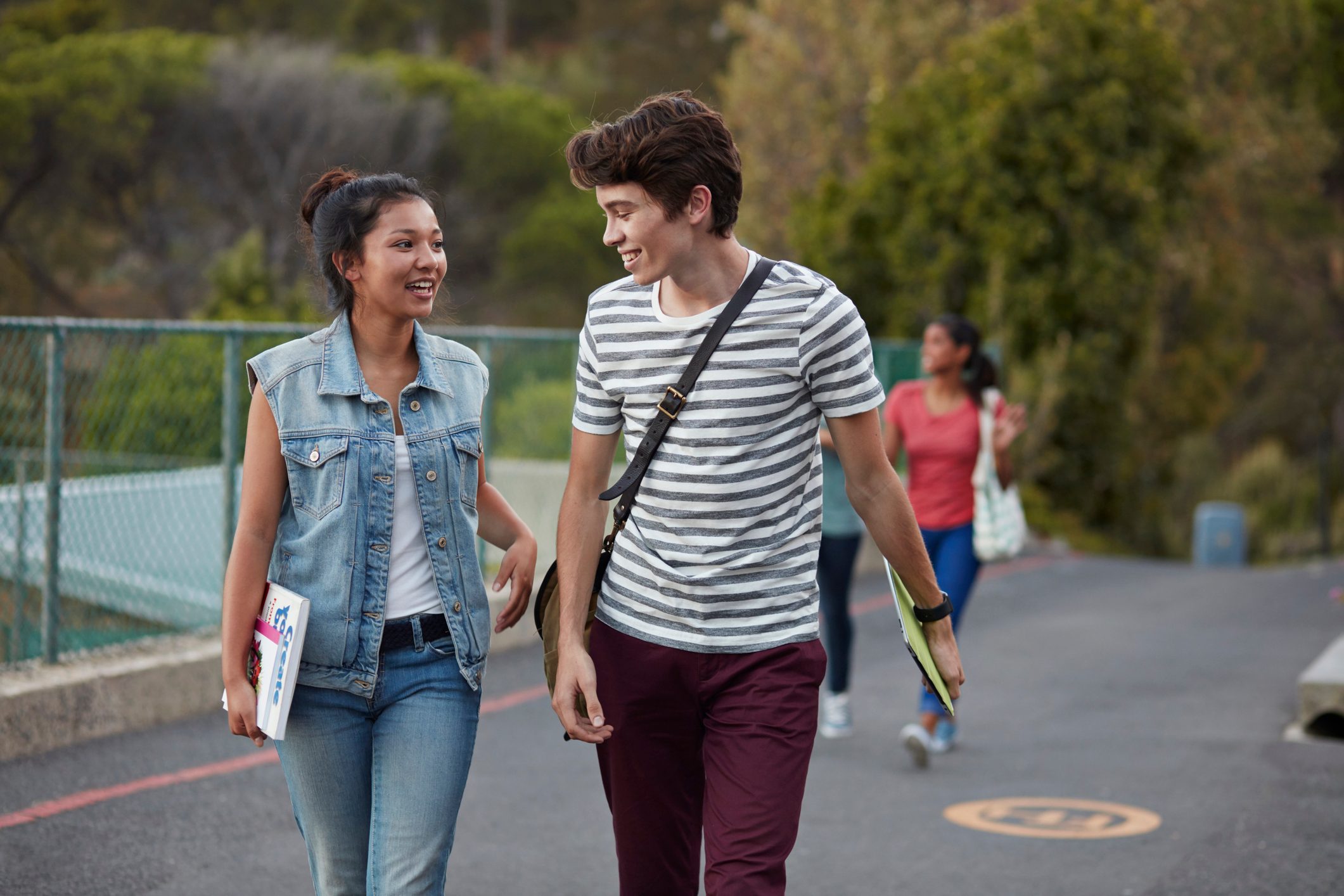 Friends walking to school together & laughing