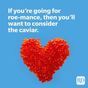 Red caviar forms a heart shape against a blue background with text: 