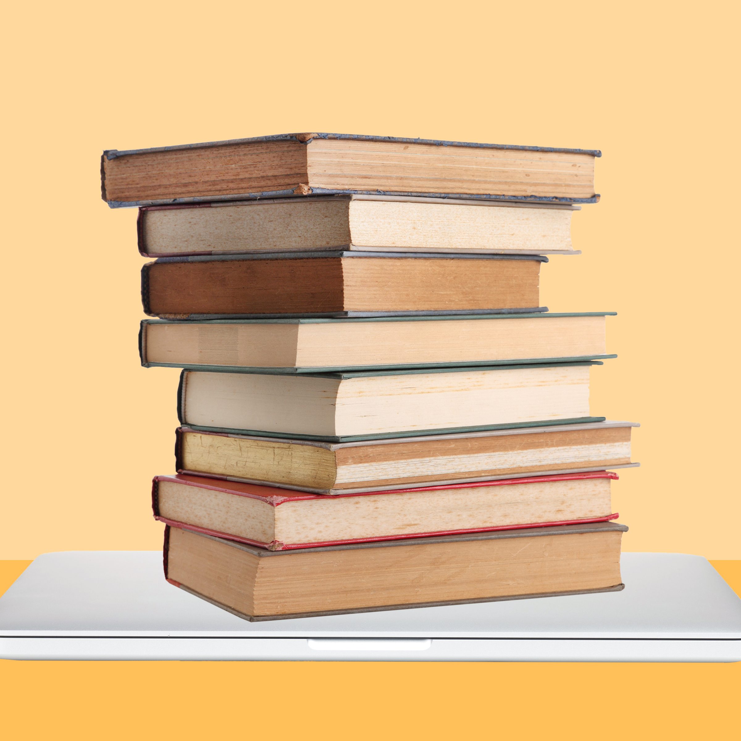 stack of used book on a laptop