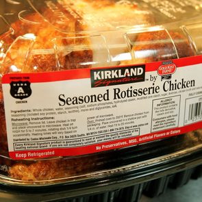 Container displays rotisserie chicken, packaged under plastic cover, with label detailing ingredients, reheating instructions, and allergy information, emphasizing freshness and quality assurance.