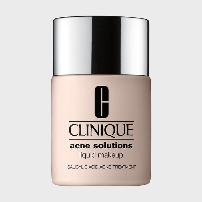 A beige makeup bottle sits upright, labeled 
