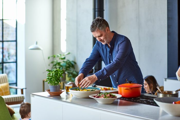 Mature man preparing healthy meal on kitchen counter