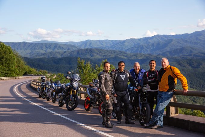 Steve Smith, from left, Sean Patel, Ed DeMik, Pinkesh Patel and Todd Patrick pose for a photo while on a motorcycle ride on the Foothills Parkway in Great Smoky Mountain National Park