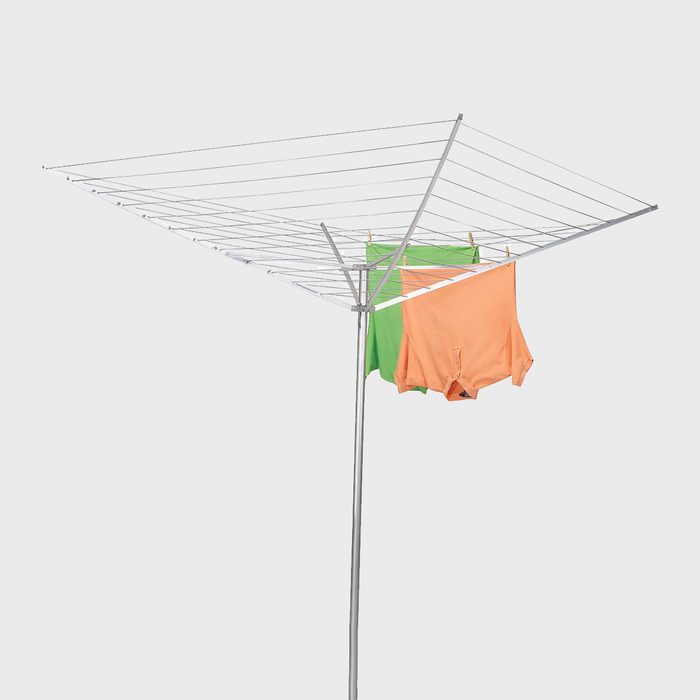 Clothes hang drying on a rotary clothesline against a plain background.