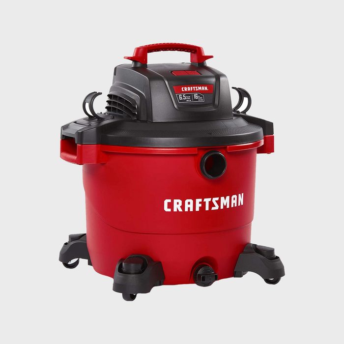 Vacuum is stationary in a plain, gray environment. It is red and black with 