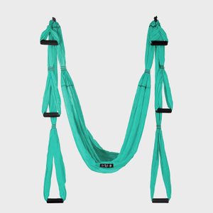 Turquoise aerial yoga swing hangs, featuring multiple padded handles, set against a plain white background.