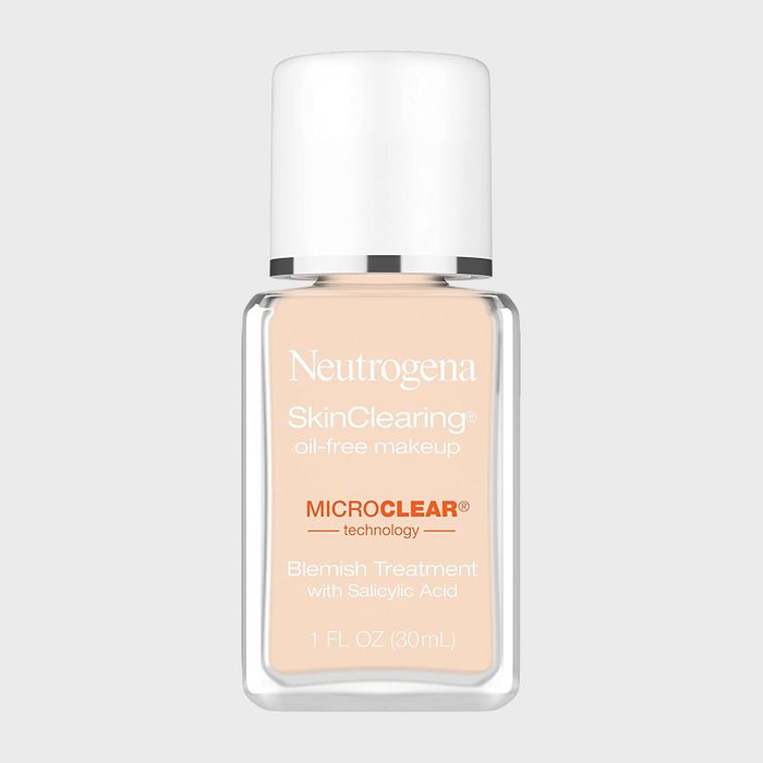 Bottle contains Neutrogena SkinClearing oil-free makeup, with MicroClear technology for blemish treatment; clear cap, beige liquid, minimalist design.