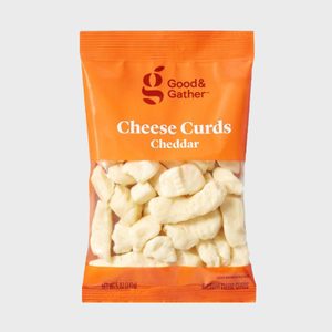 A bag of cheddar cheese curds rests inside orange packaging, labeled 