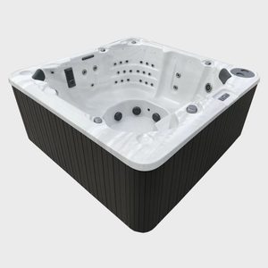 Hot tub sits empty with multiple jets visible, surrounded by sleek, dark paneling in a well-lit environment.