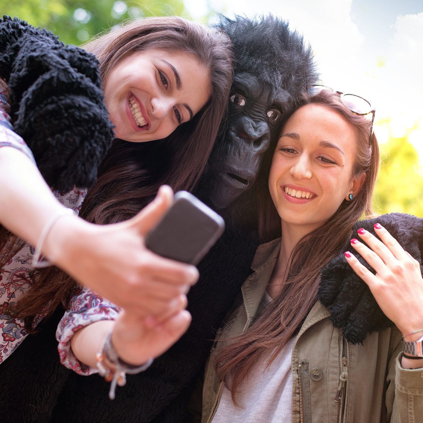 Happy friends and a Gorilla Taking Photo with Mobile Phone