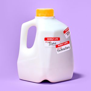 Milk jug stands with red labels reading 