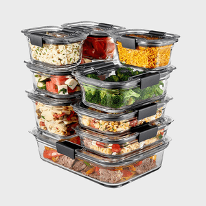 Glass containers stack, holding various foods like broccoli, pasta, and vegetables; neatly arranged against a plain background.