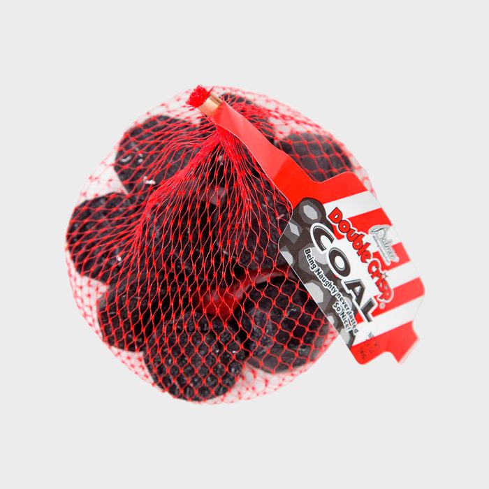 Red netting bag holds black lumps labeled 