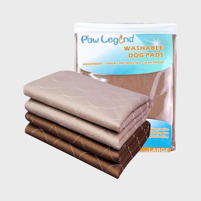 Folded dog pads stacked neatly; package behind with text 