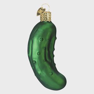 Green pickle ornament hanging with a gold cap and heart-shaped tag, isolated on a plain background.