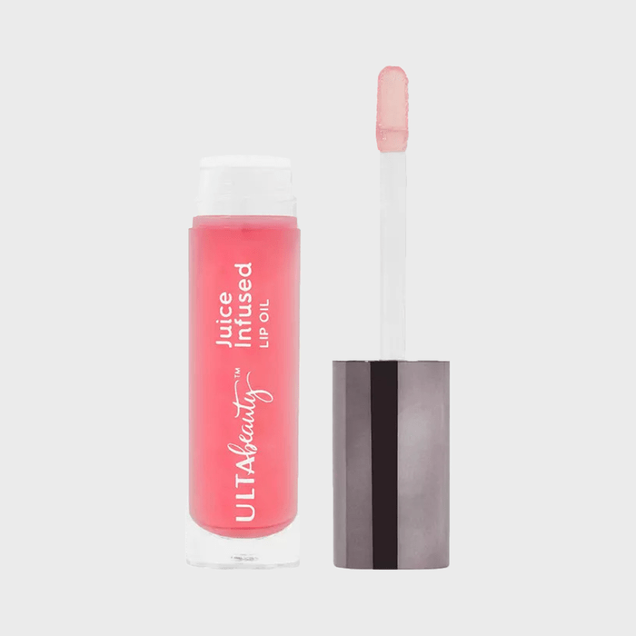 Lip oil container, open with applicator exposed, labeled 