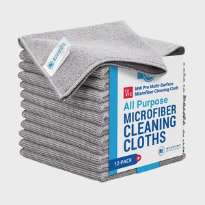 Stacked grey microfiber cloths sit in packaging labeled 