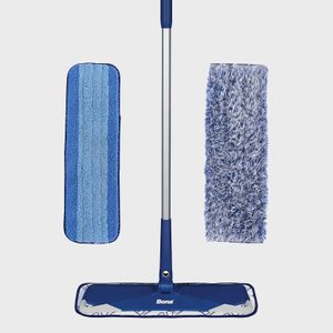 Mop with blue handle standing upright, accompanied by two detachable microfiber pads; one striped and the other fluffy, all on a plain background.