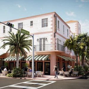 Building displays pastel architecture, striped awnings; people dining outside on the corner of a sunny street labeled 